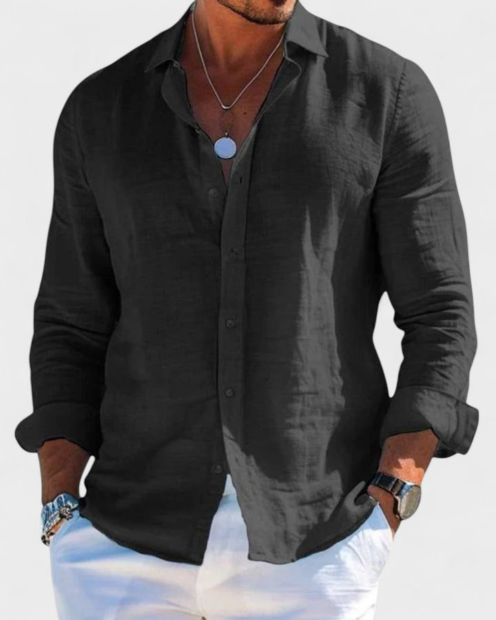 Men's Blake black linen button-up shirt with a classic collar, styled casually with white pants.