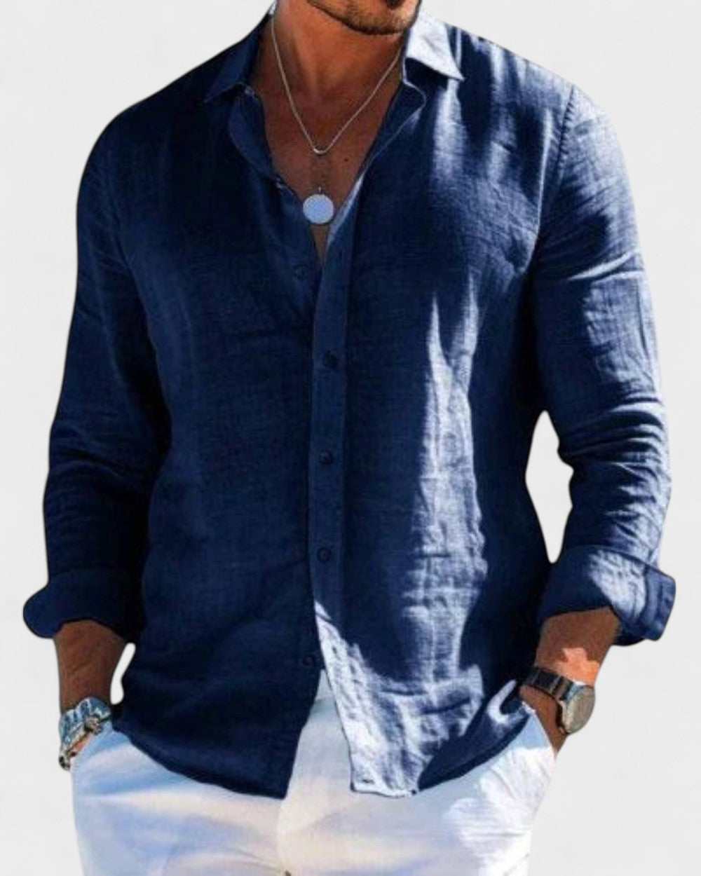 Men's Blake navy linen button-up shirt with a classic collar, styled with white pants.