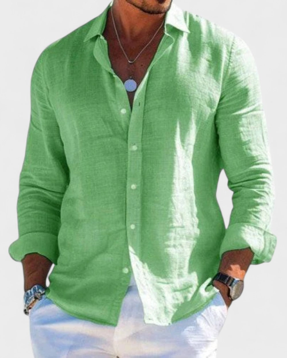 Men's Blake lightweight green linen button-up shirt with classic collar, styled with white pants.