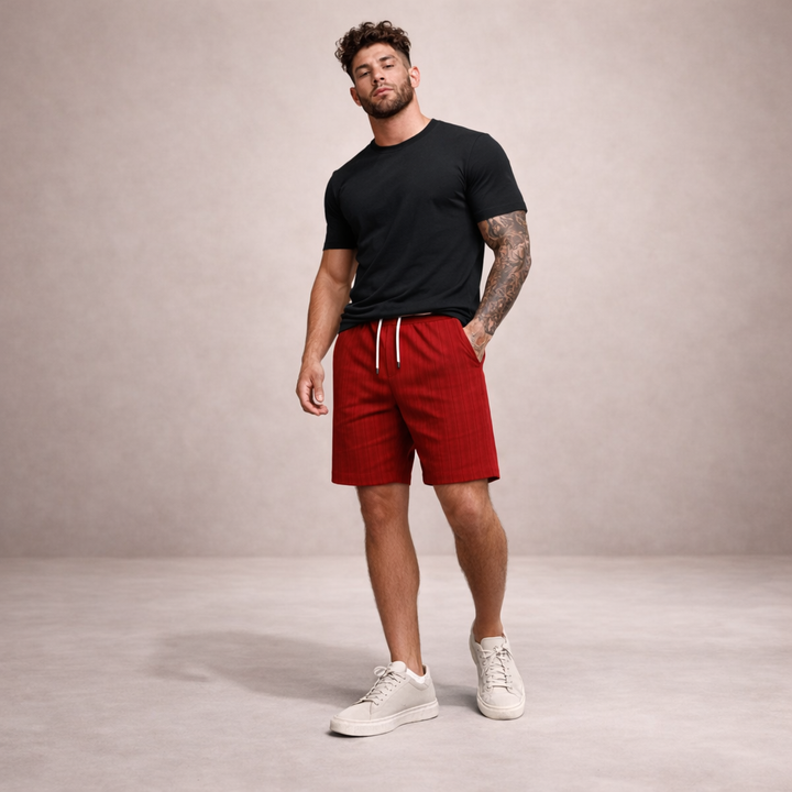 Men's Brandon red plaid linen summer shorts with white drawstring, paired with a black tee and white sneakers.