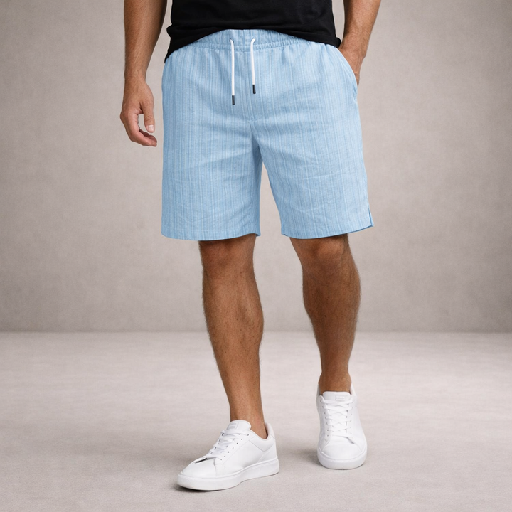 Men's light blue linen drawstring shorts with subtle vertical stripes, above-knee length, and side pockets.