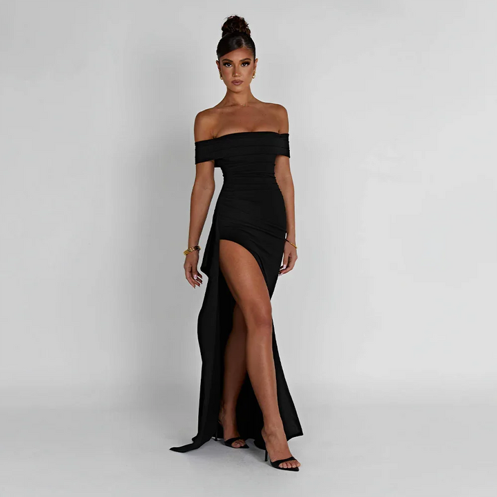 Black off-shoulder maxi dress with a high slit, flowing fabric.