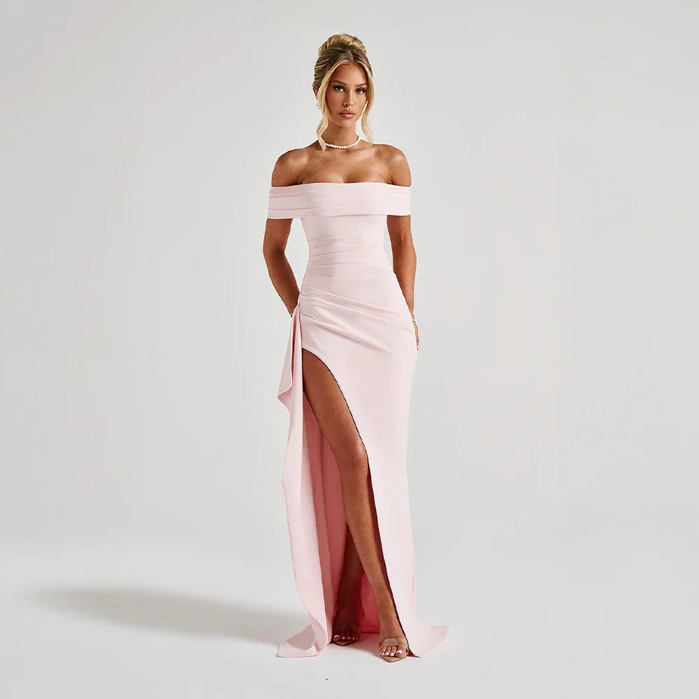 Pink off-shoulder maxi dress with a high slit, flowing fabric, and elegant design.