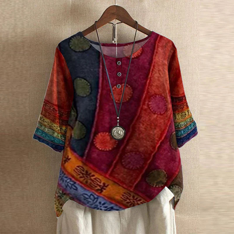 Women's relaxed-fit floral blouse with a button-front placket, three-quarter sleeves, and a vibrant, multicolored print.