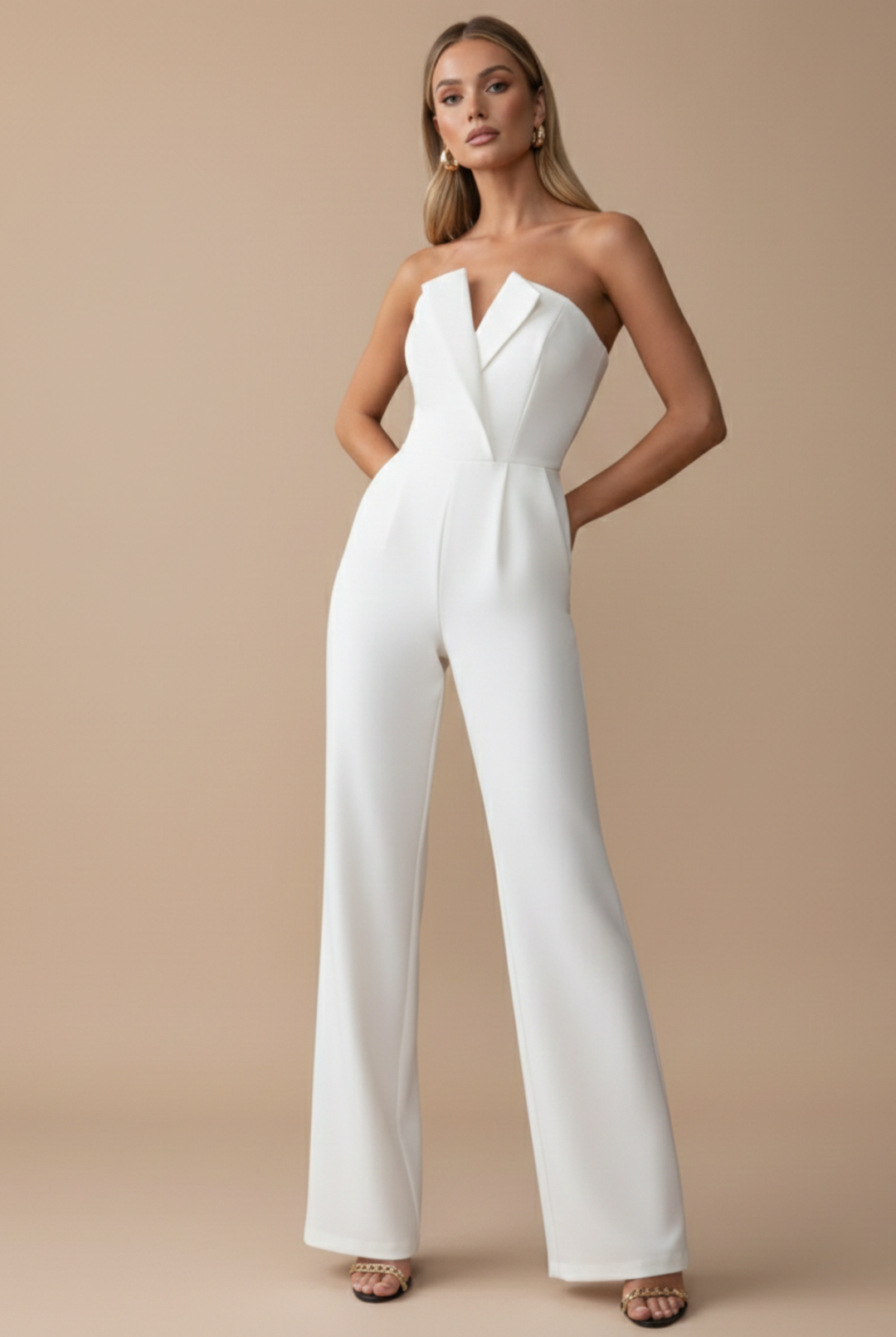 Women's white strapless wide-leg jumpsuit with tailored bodice, V-neck detail, and side pockets.