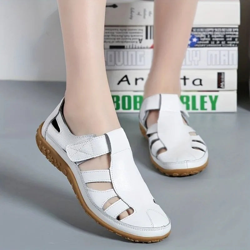 White leather Clara closed-toe fisherman sandals with a flexible brown flat sole.
