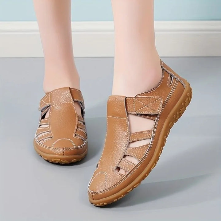 Brown leather Clara closed-toe fisherman sandals with breathable cutouts and a flexible flat sole.
