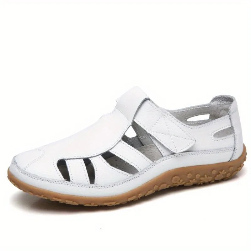 White leather Clara closed-toe fisherman sandals with a textured tan flat sole.