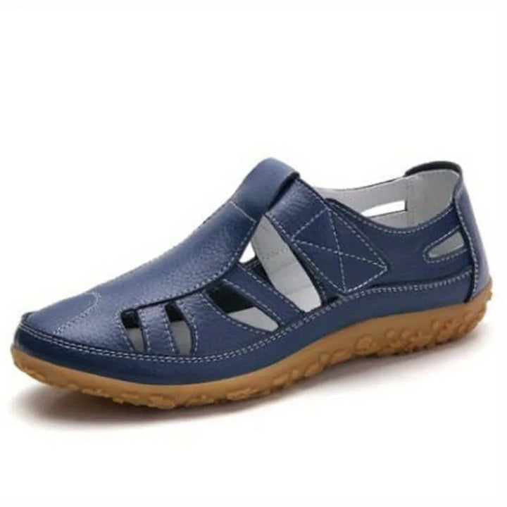 Blue leather Clara closed-toe fisherman sandals with a flexible tan sole.