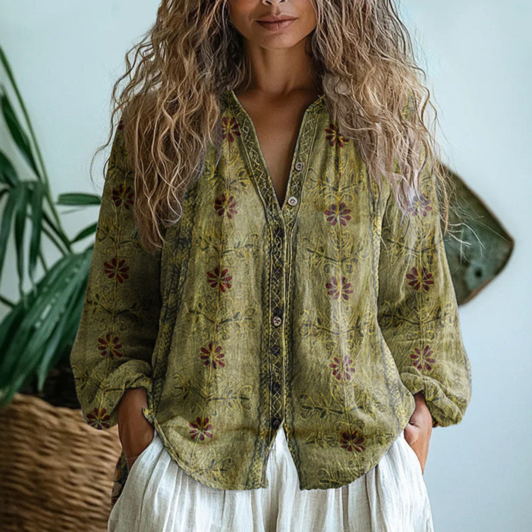 Olive green linen button-down blouse featuring a floral print, long sleeves, and contrast trim along the placket.