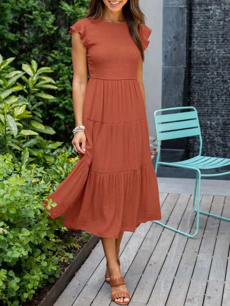 Clara Women's Tiered Cap Sleeve Midi Dress in rust, featuring a fitted bodice, flowing tiered skirt, and cap sleeves.