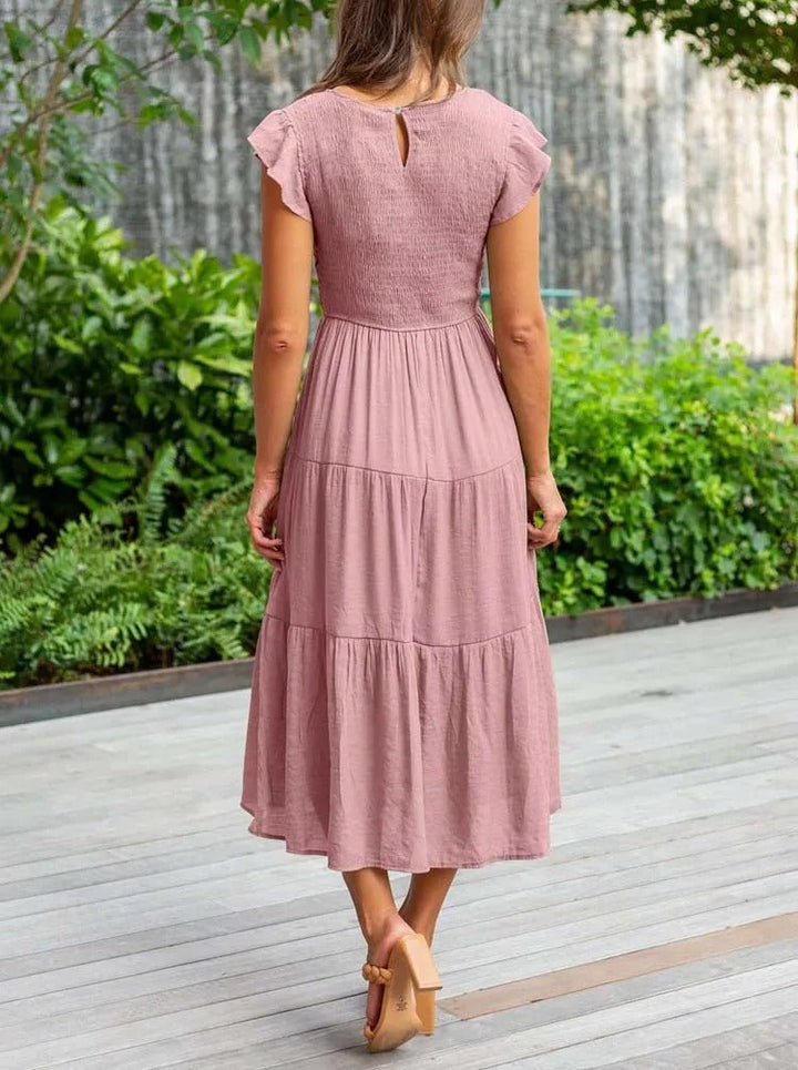 Clara women's tiered cap sleeve midi dress in dusty rose, featuring a fitted bodice and flowing skirt.
