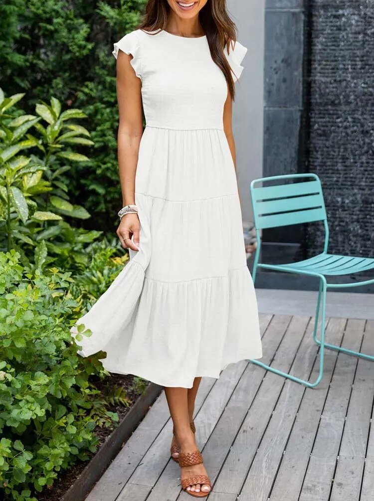 Clara white tiered cap sleeve midi dress with a fitted bodice, flowing skirt, and soft cap sleeves.