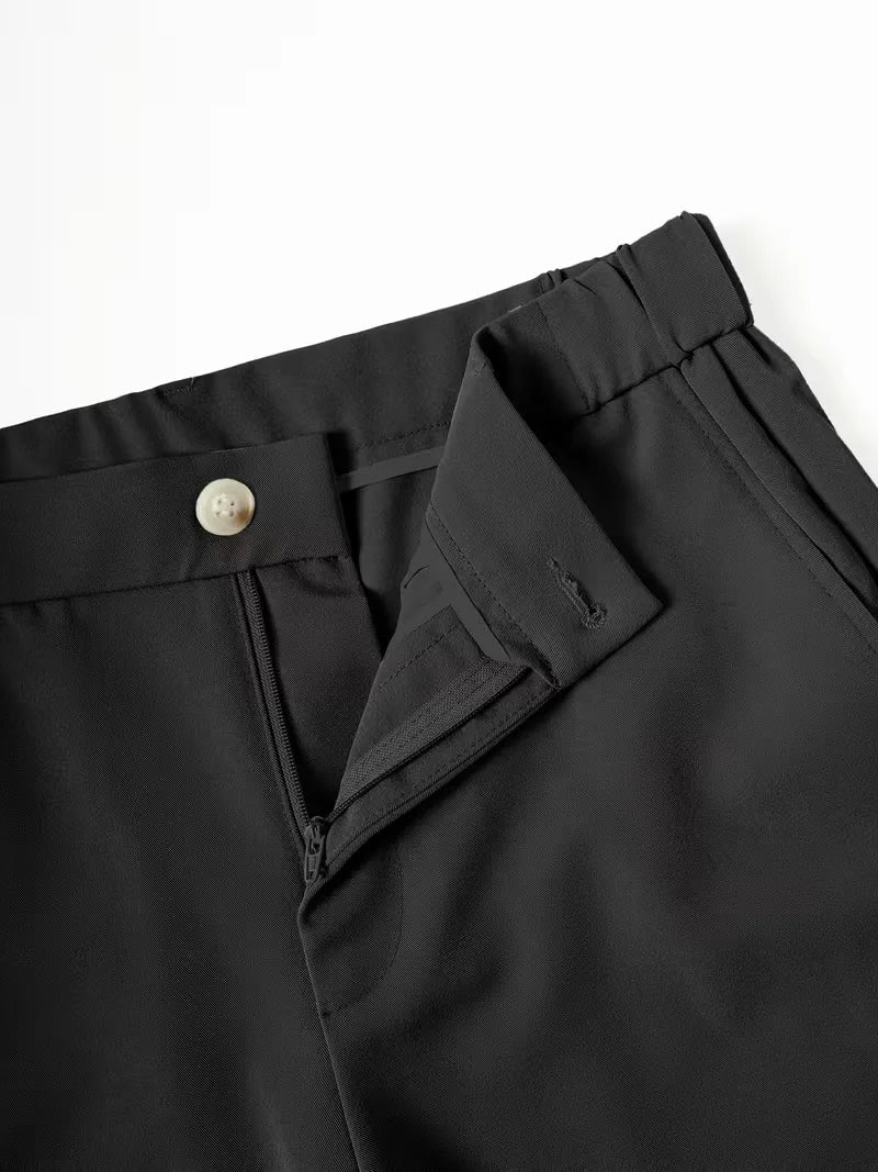 Close-up of Cole men's black lightweight straight leg shorts, featuring a light button, zipper, and belt loops.