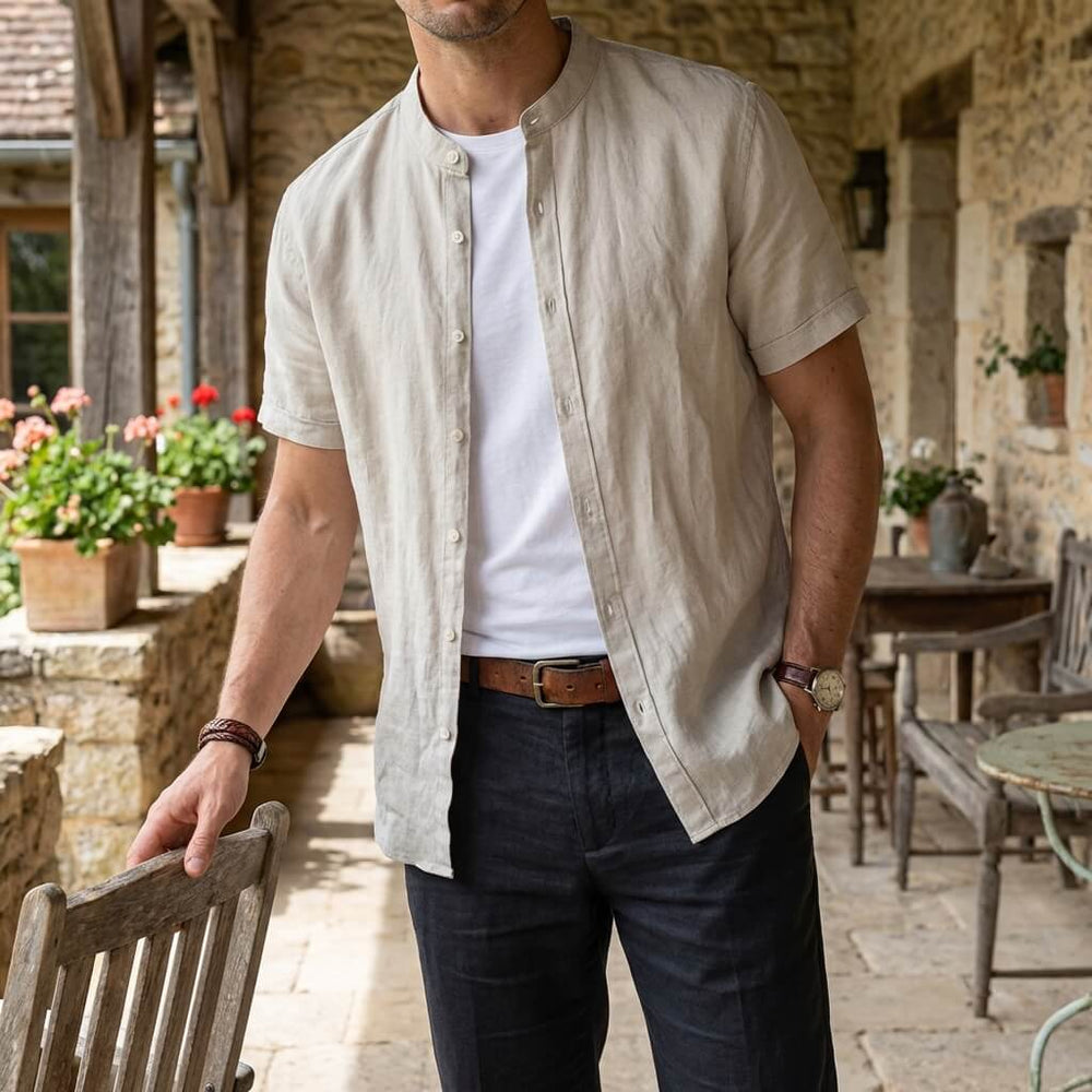 Men's Cole short sleeve natural linen shirt with a stand collar, worn open over a white tee.