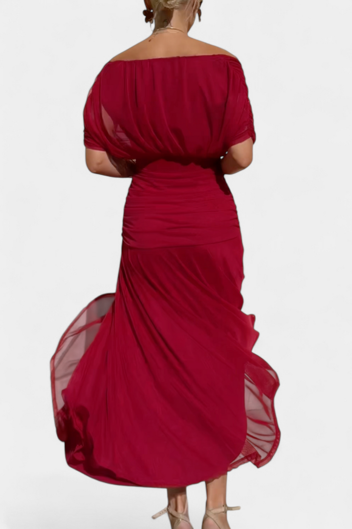Women's floral off-shoulder maxi dress with a ruched waist, flowing skirt, and vibrant print.