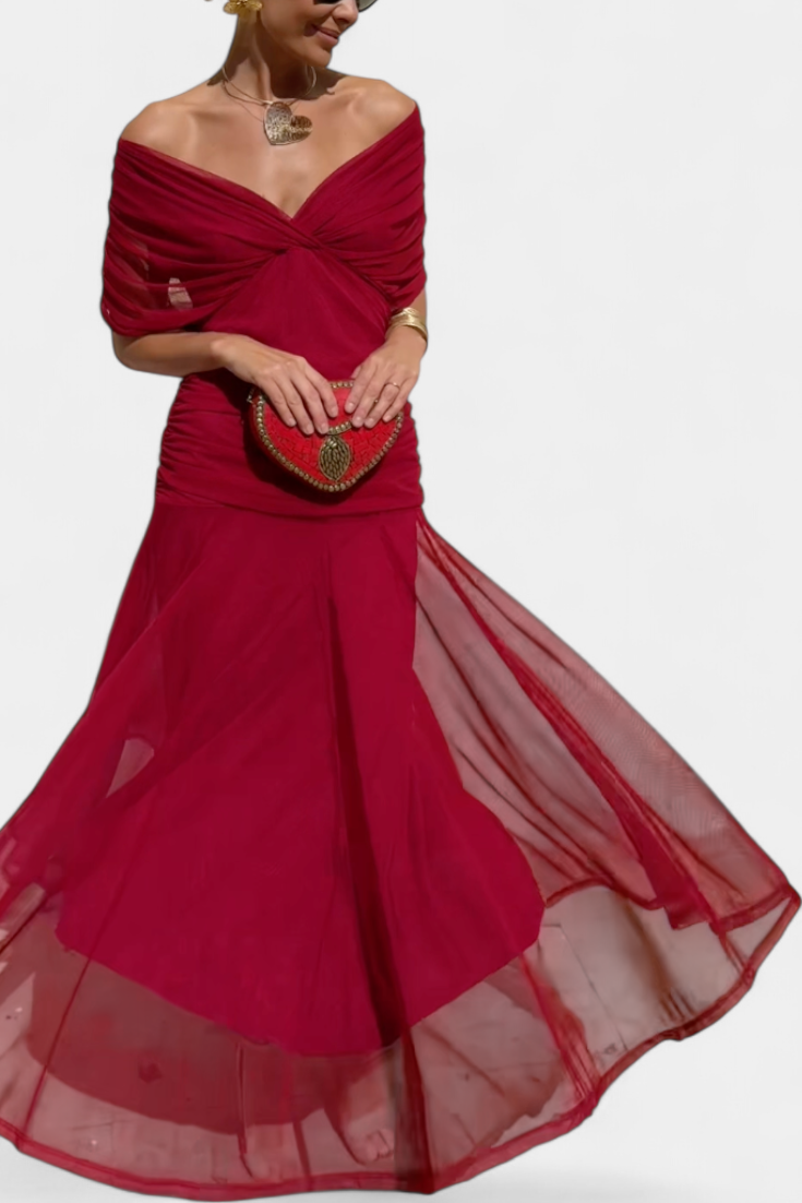 Women's off-shoulder floral maxi dress with a ruched waist, flowing skirt, and vibrant print.