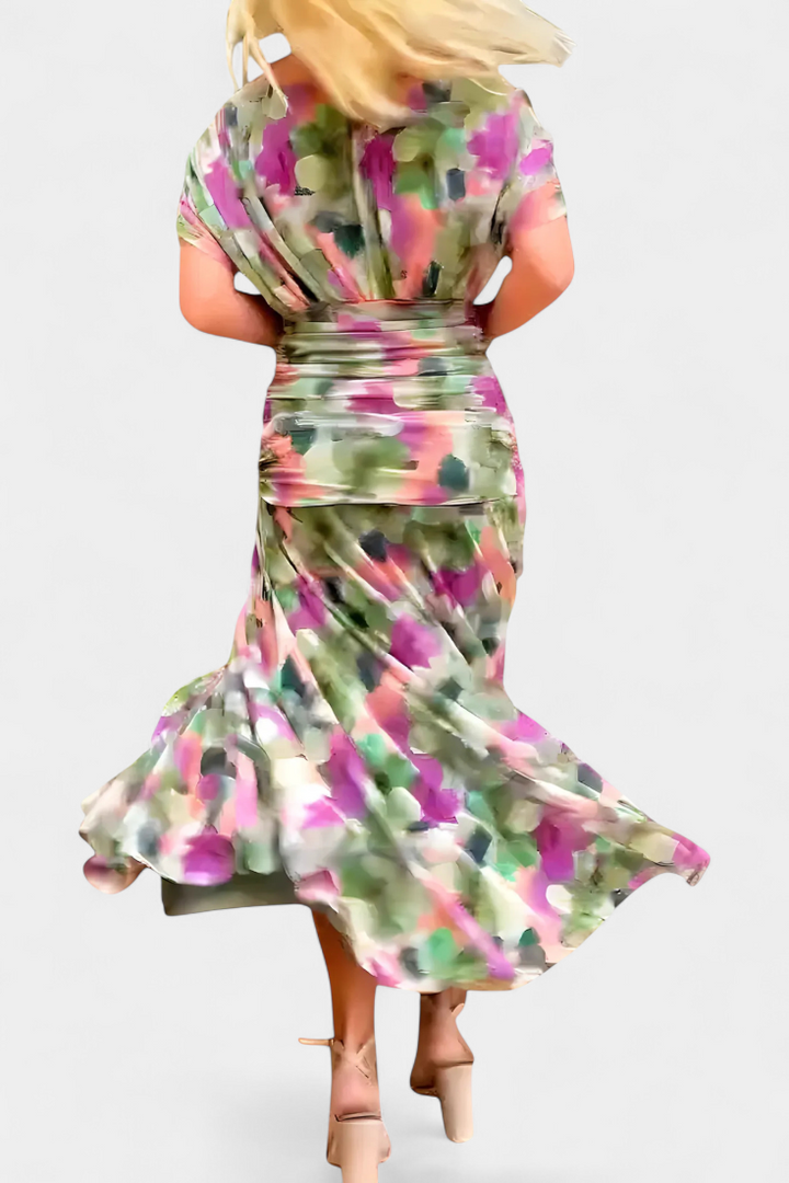 Women's off-shoulder floral maxi dress with a ruched waist, flowing skirt, and vibrant print.