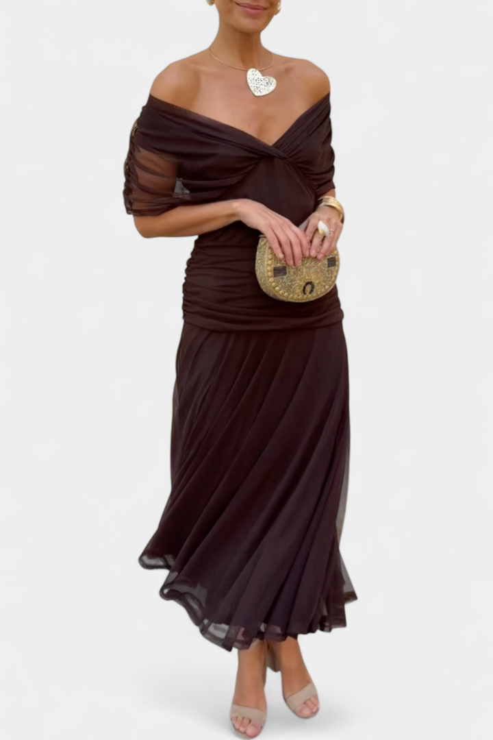 Women's off-shoulder floral maxi dress with a ruched waist, flowing skirt, and vibrant print.
