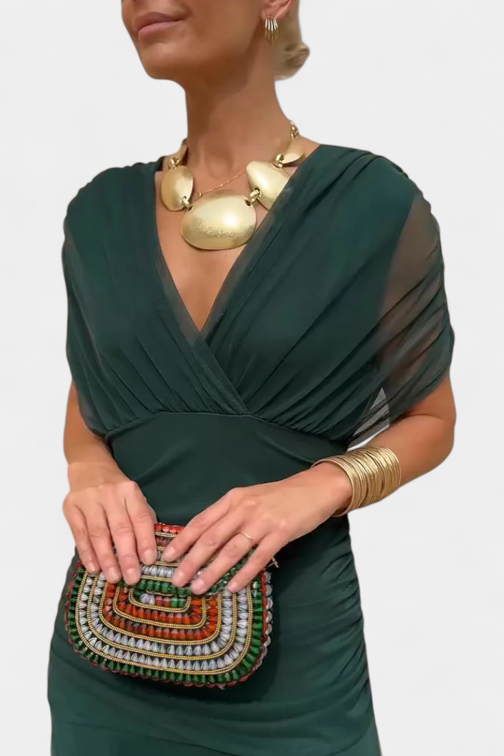 Green floral off-shoulder maxi dress with a ruched waist, flowing skirt, and short sleeves.