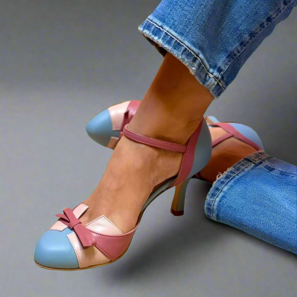 Daphne colorblock ankle strap heels in blue, pink, and beige leather with a bow detail, worn with jeans.