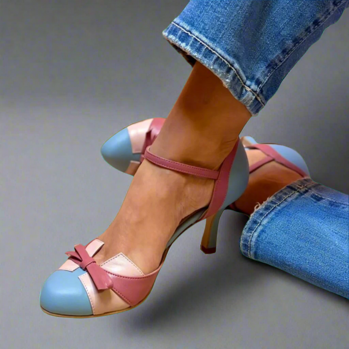 Daphne colorblock ankle strap heels in blue, pink, and beige leather with a bow detail, worn with jeans.