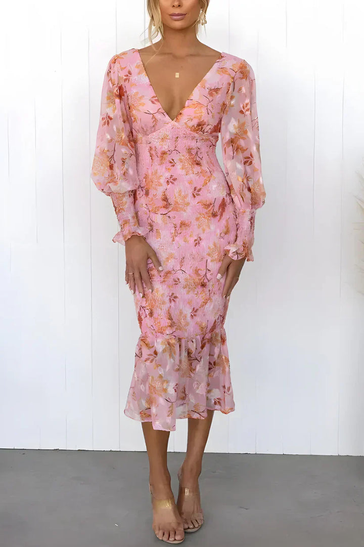 Women's Davina pink floral smocked V-neck midi dress with sheer long sleeves and ruffle hem.