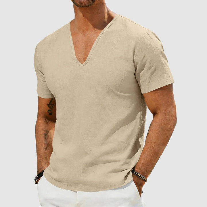 Men's Declan short sleeve linen V-neck shirt in a light beige color, worn by a model.