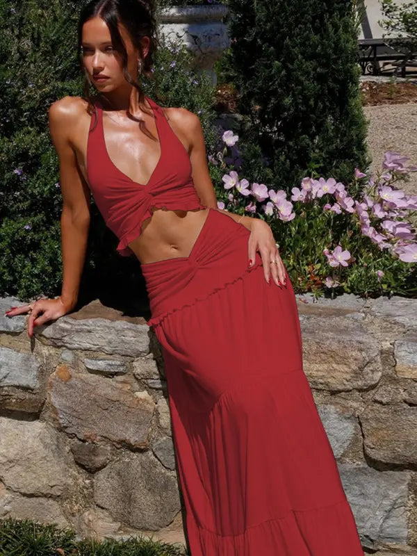 Woman in the red Delilah plunge neck halter top and matching tiered maxi skirt.