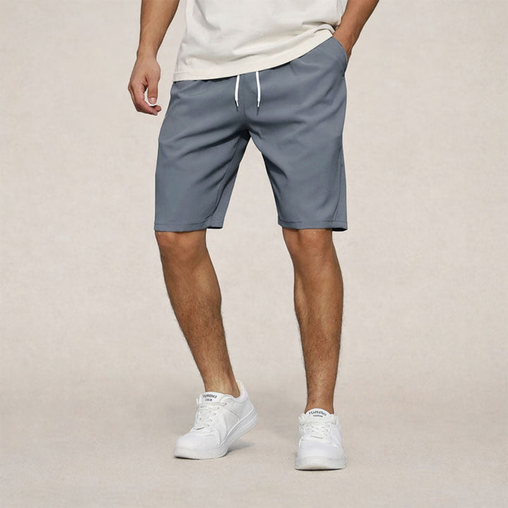 Men's Dominic drawstring knee-length shorts in slate gray with white drawstring and side pockets.