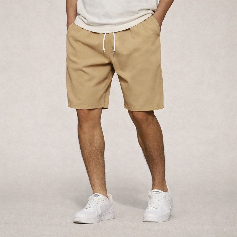 Men's Dominic knee-length drawstring shorts in tan, featuring side pockets and a relaxed fit.