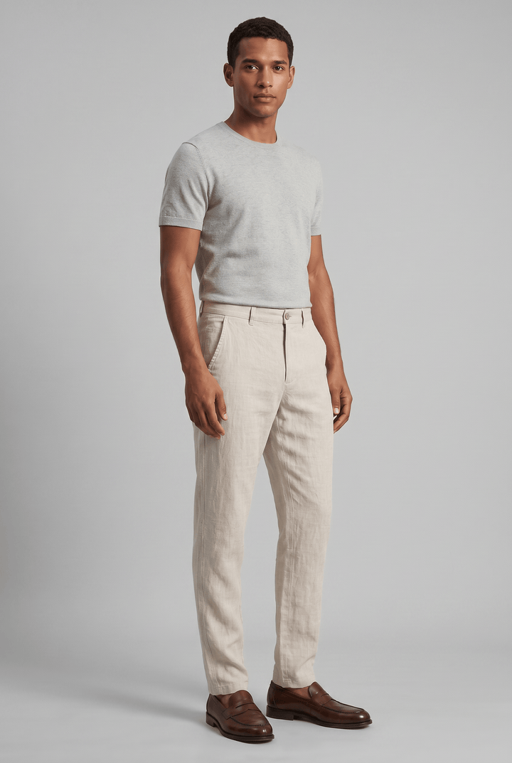 Men's Drew slim fit linen chinos in a light beige, paired with a gray tee and brown loafers.