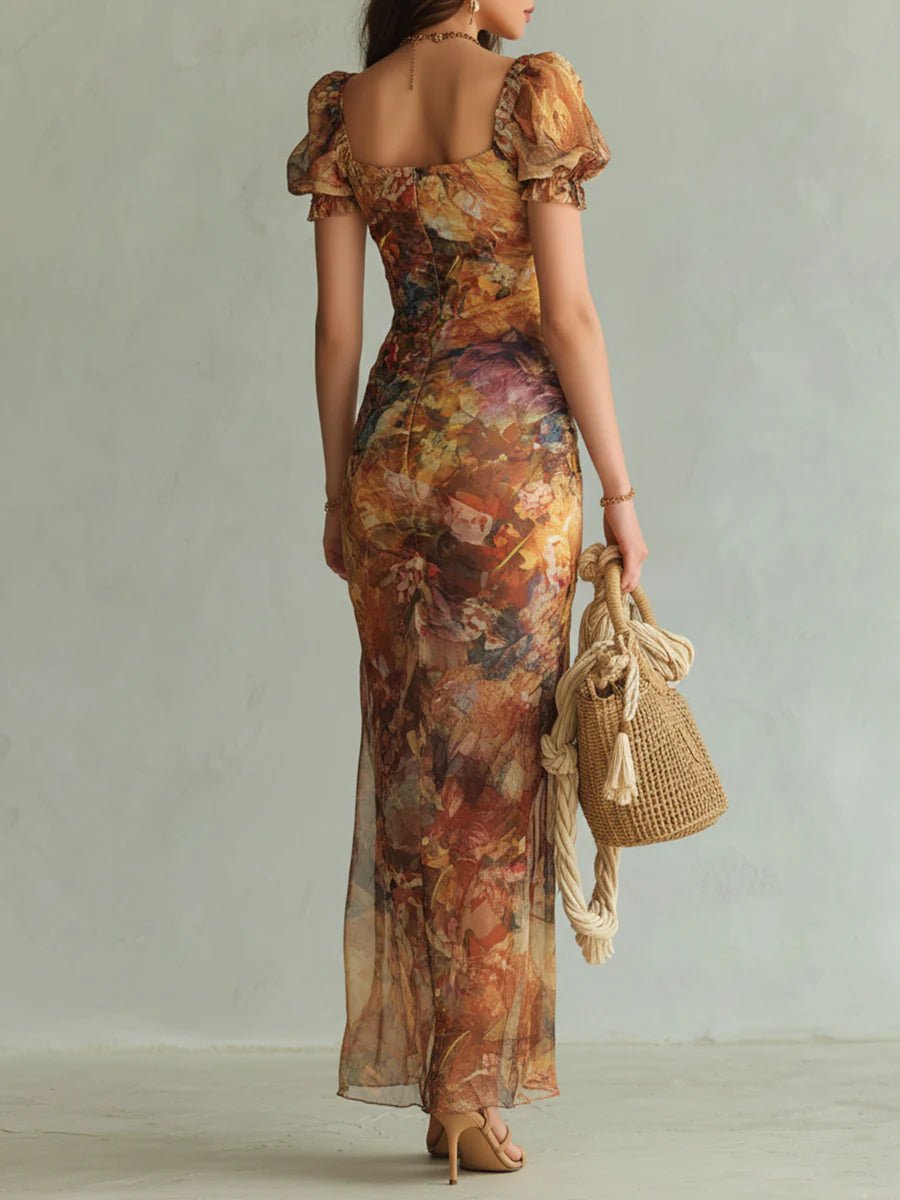 Woman in a flowing brown floral chiffon maxi boho dress with ruffle sleeves, holding a woven bag.