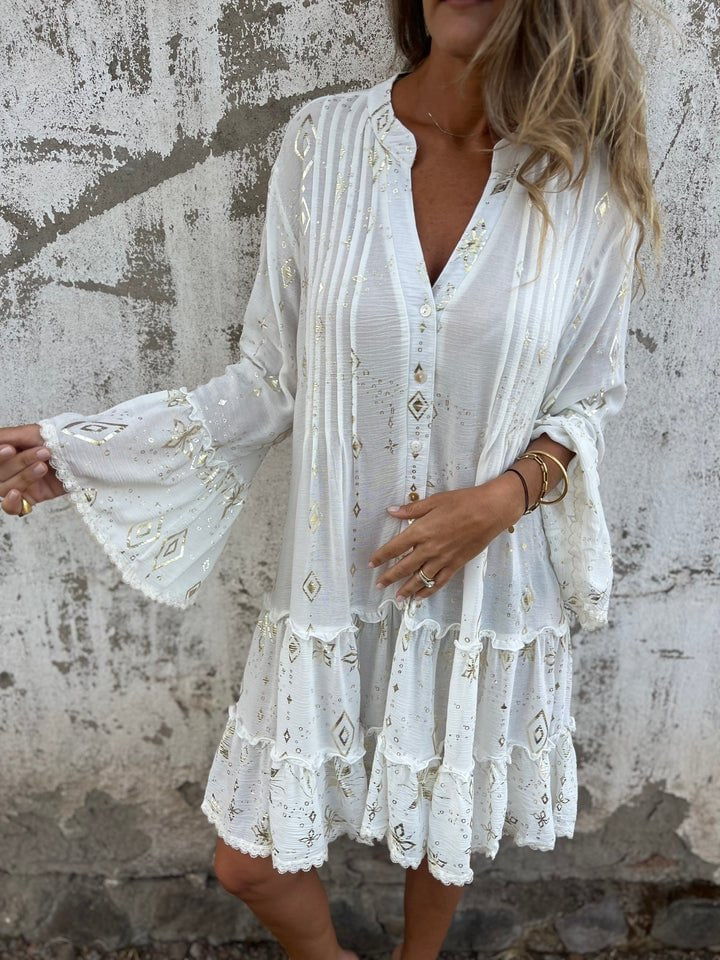 Women's white tiered boho V-neck dress with gold-tone accents and three-quarter sleeves.