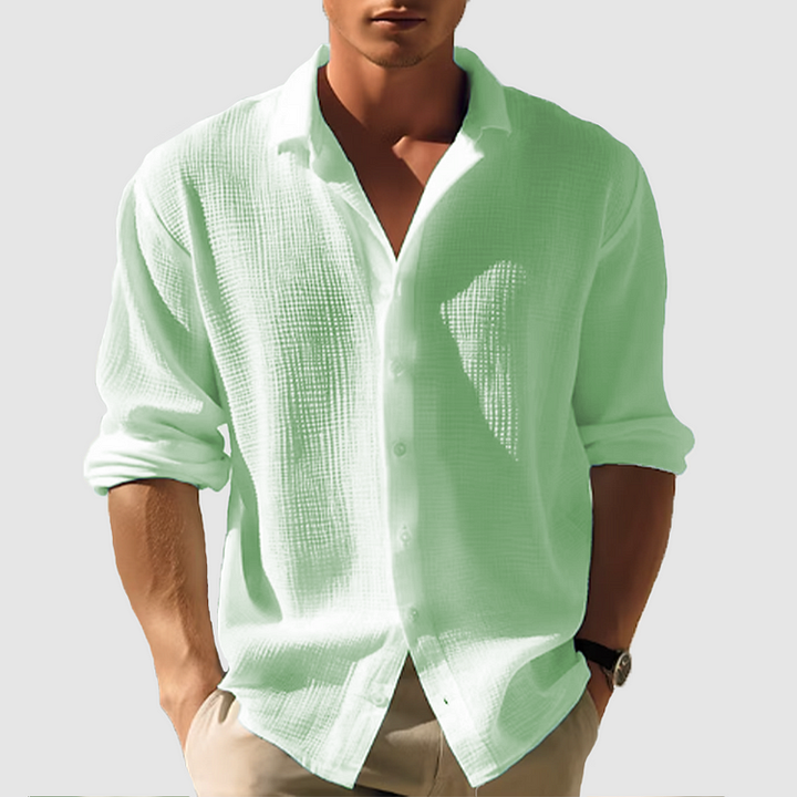 Men's light green linen button-up shirt with long rolled sleeves and a collared neckline.