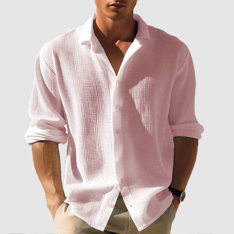 Men's Ethan pink linen button-up shirt with long rolled sleeves and a collared neckline.