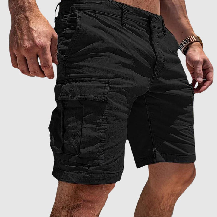 Men's black knee-length cargo shorts with side flap pockets and belt loops for easy utility style.