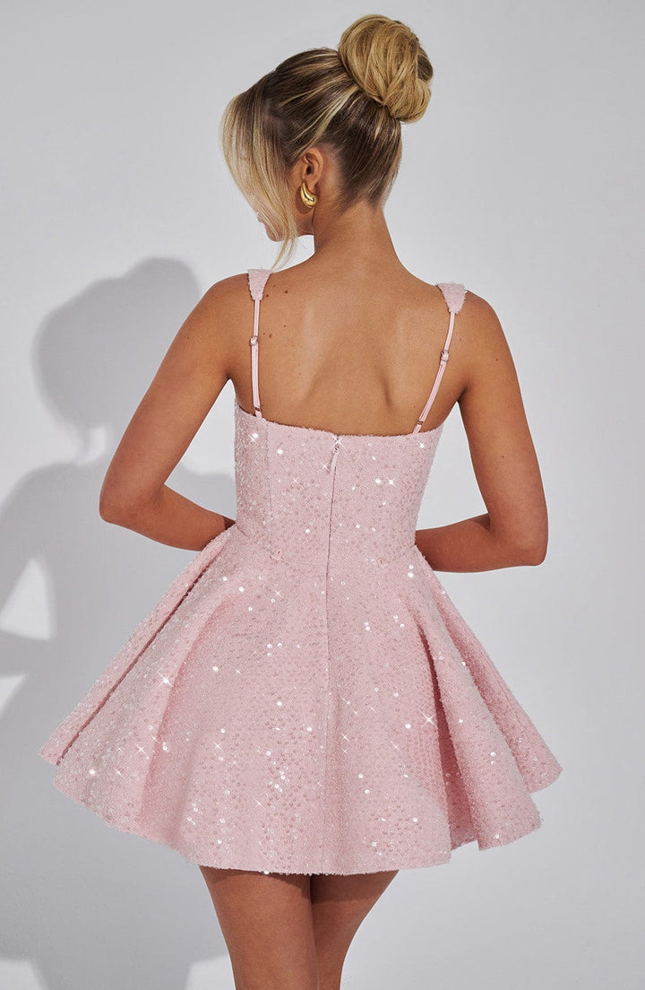 Back view of a pink sequin mini dress with a flared skirt and thin straps.