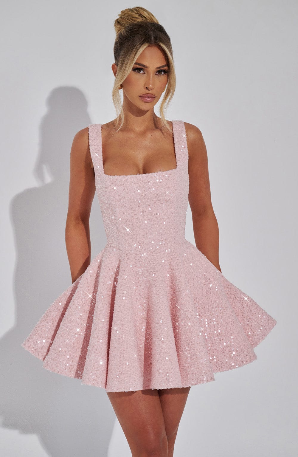 Pink sequin mini dress with a square neckline and flared skirt.