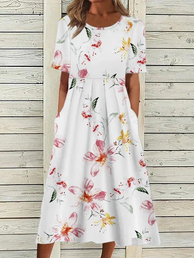 White floral printed midi dress with short sleeves, round neckline, gathered waist, and side pockets.