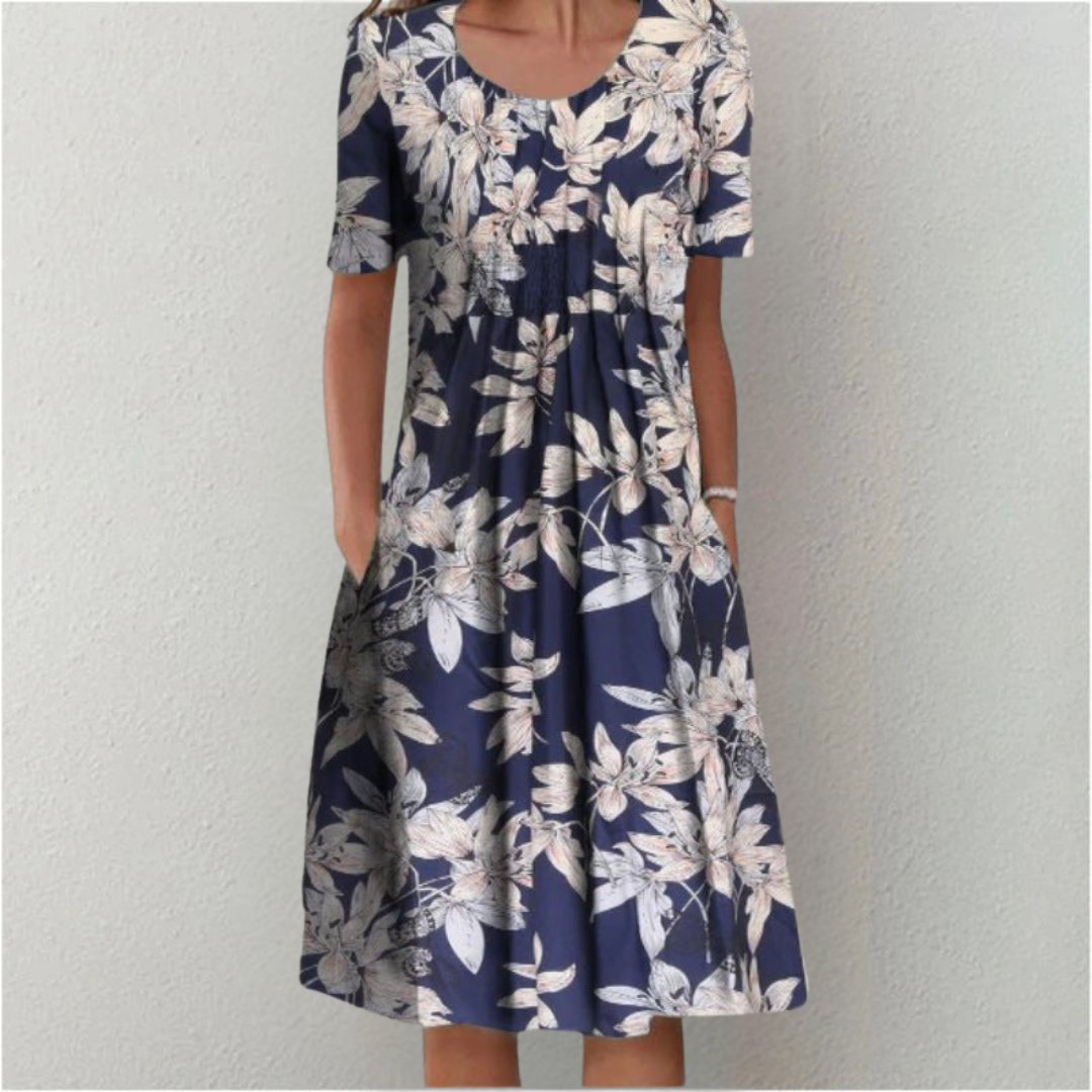 Women's blue and white floral midi dress with short sleeves and pockets.