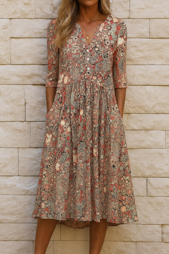 Beige women's printed midi dress with V-neck, 3/4 sleeves, and a flowing skirt.