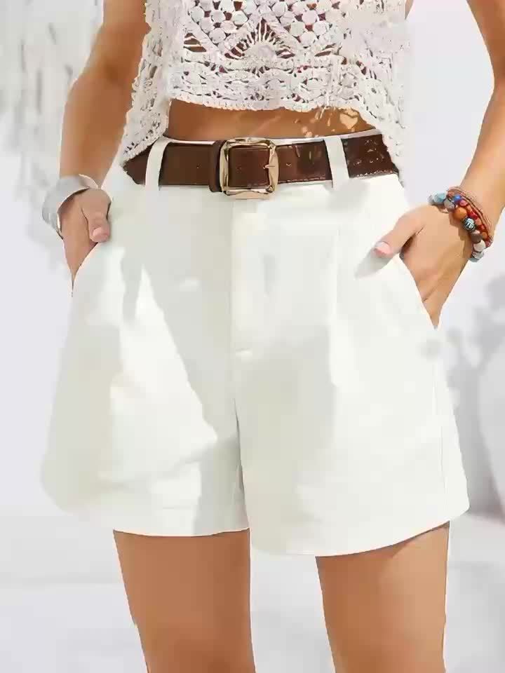 White high-waisted Harper shorts with side pockets and a brown belt.