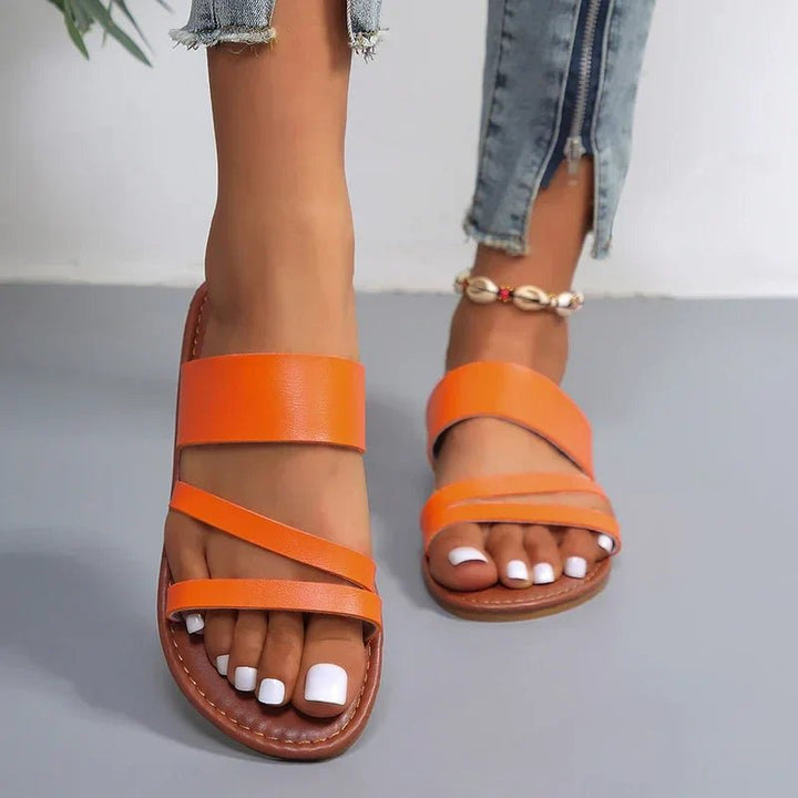 Orange Hattie women's cross strap flat sandals with a comfortable sole.