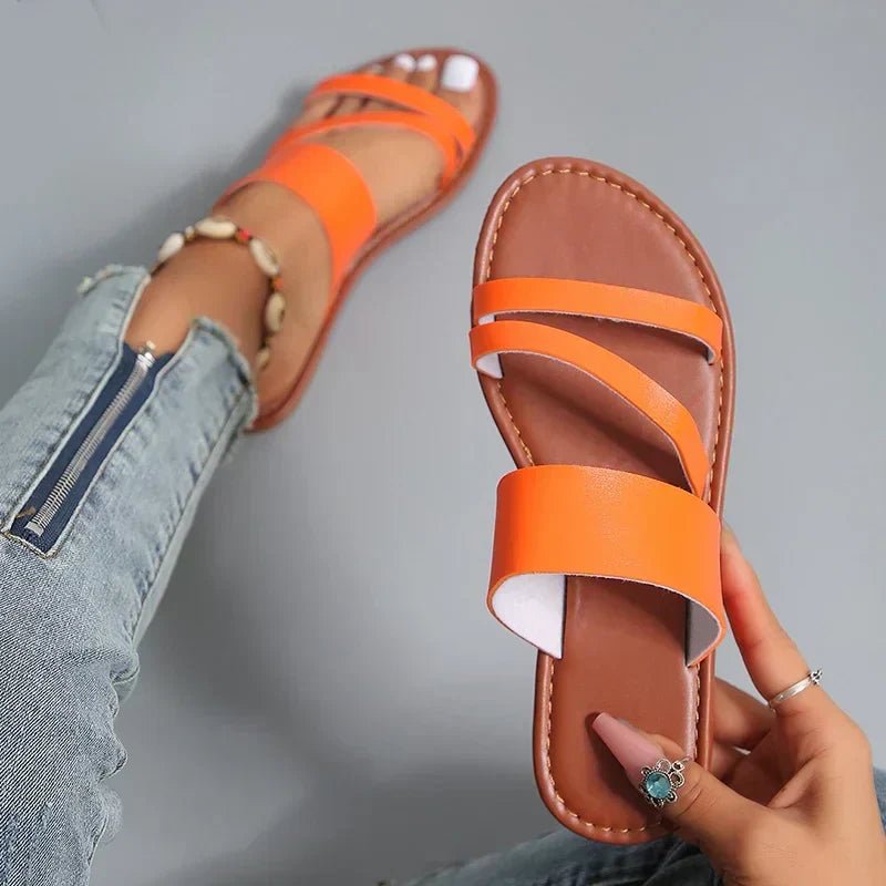 Women's Hattie cross-strap flat sandals in tan leather with a minimalist design.