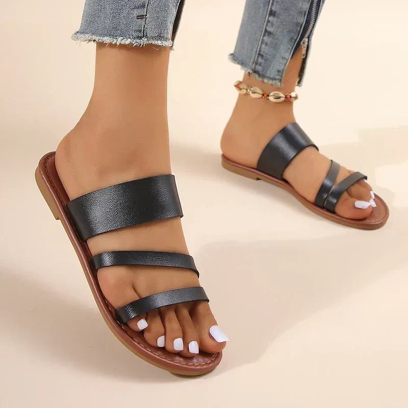 Black women's Hattie cross-strap flat sandals with a comfortable sole.