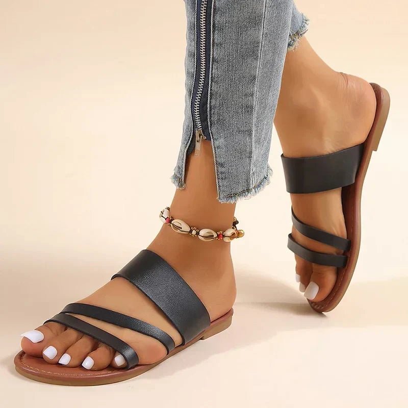 Tan leather women's cross strap flat sandals with a low heel, perfect for summer.