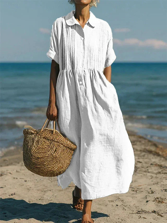 Hazel white collared button-front midi dress with short sleeves, pockets, and a relaxed, airy silhouette.
