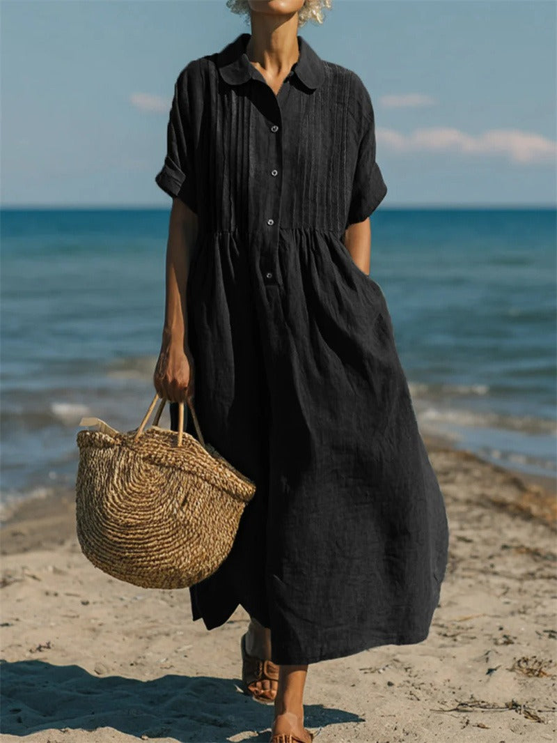 Hazel women's black collared button midi dress with short sleeves, worn on a beach.