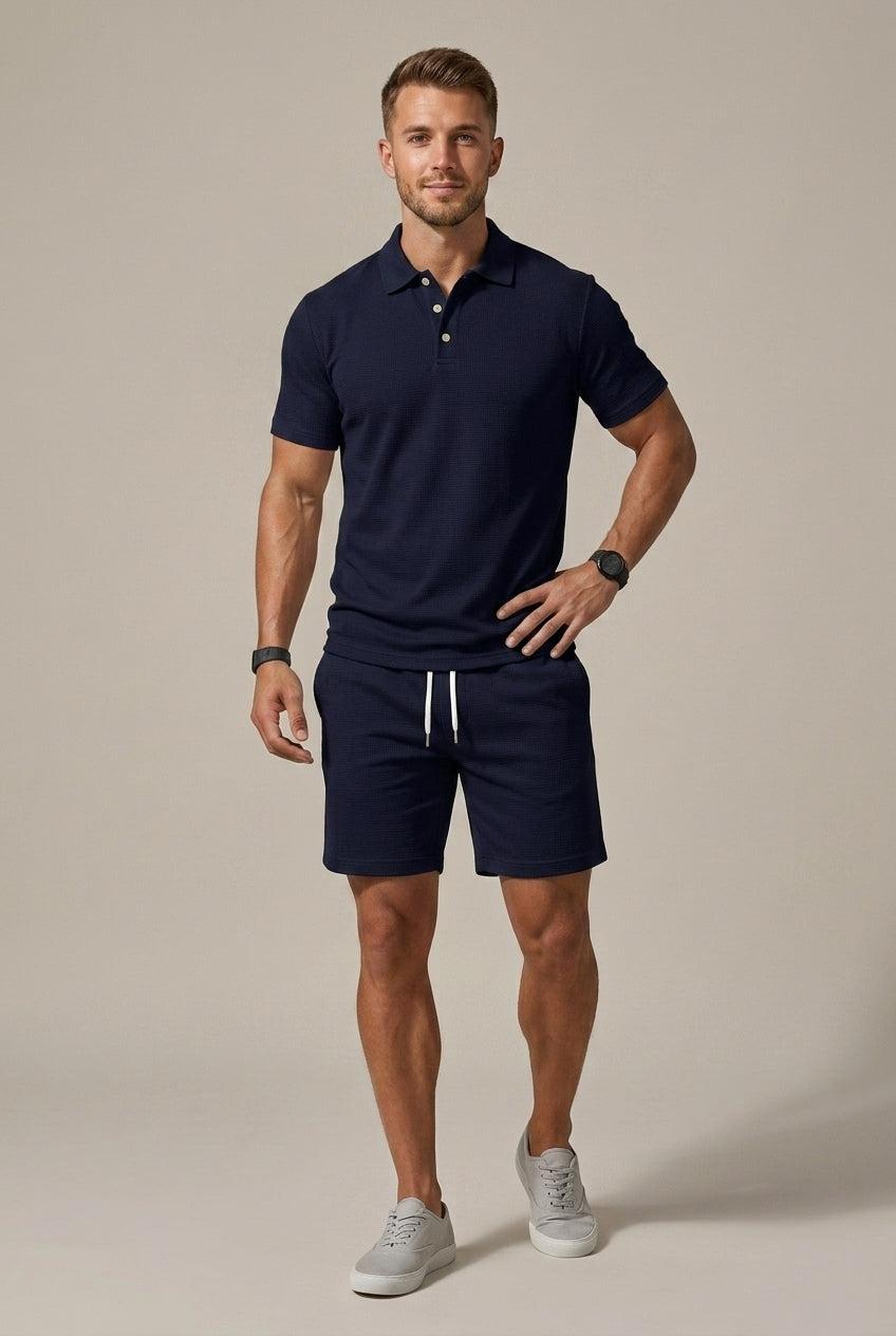 Men's navy blue ribbed polo shirt and matching drawstring shorts set.